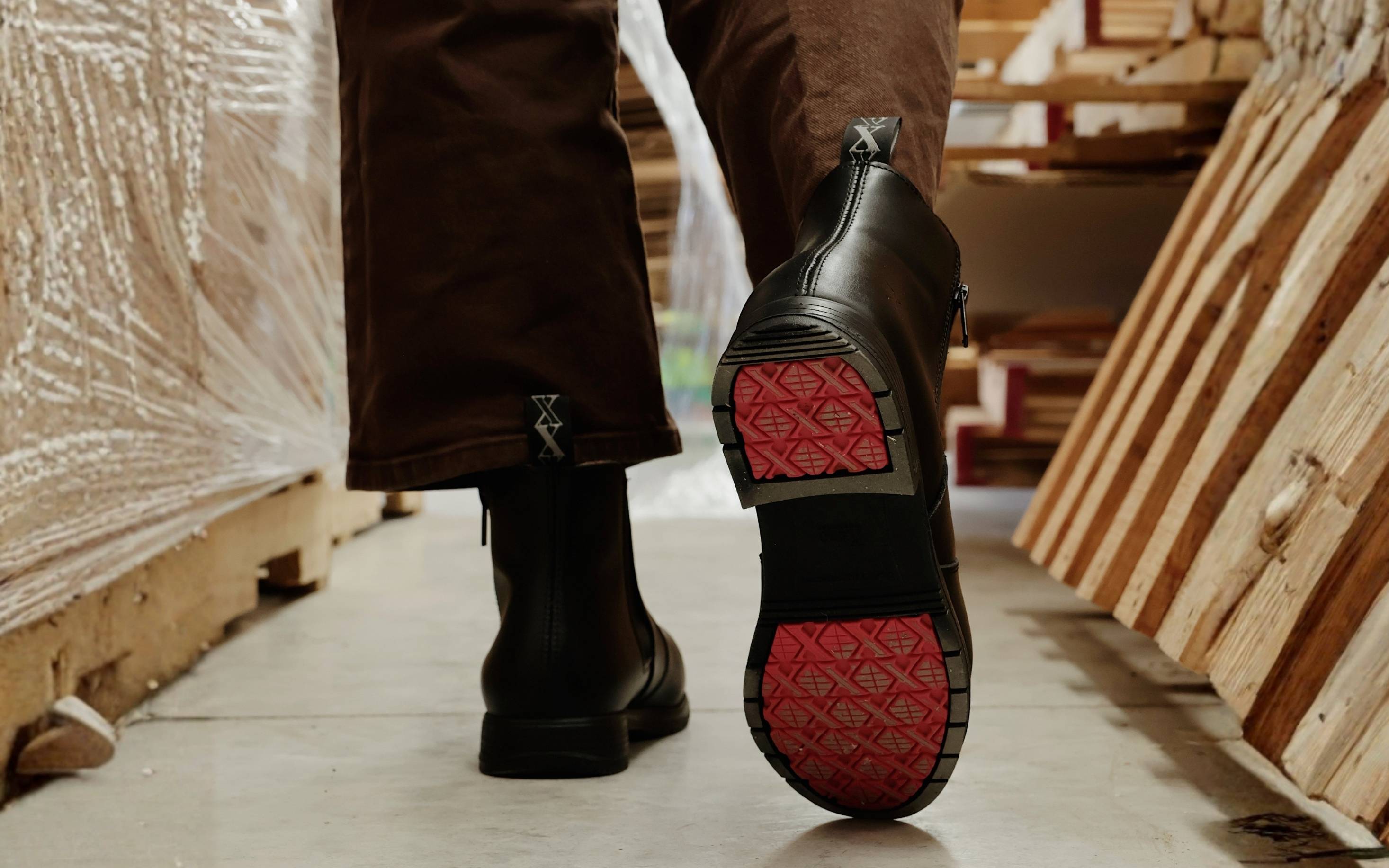 Omega EH Steel Toe Safety Boot for Women — Coral · lifestyle photo worn on the job site, coral accent outsole visible