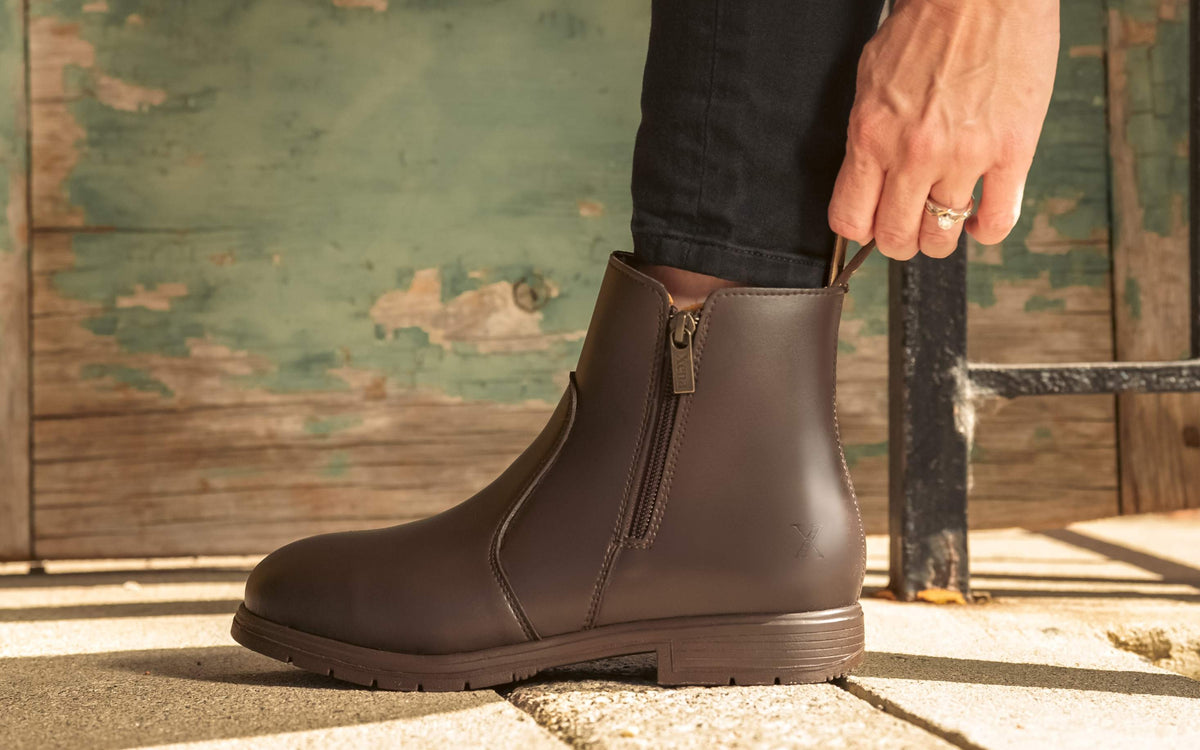 Xena Workwear Omega EH Vegan Brown women's vegan steel toe safety boots — lifestyle photo with weathered door background