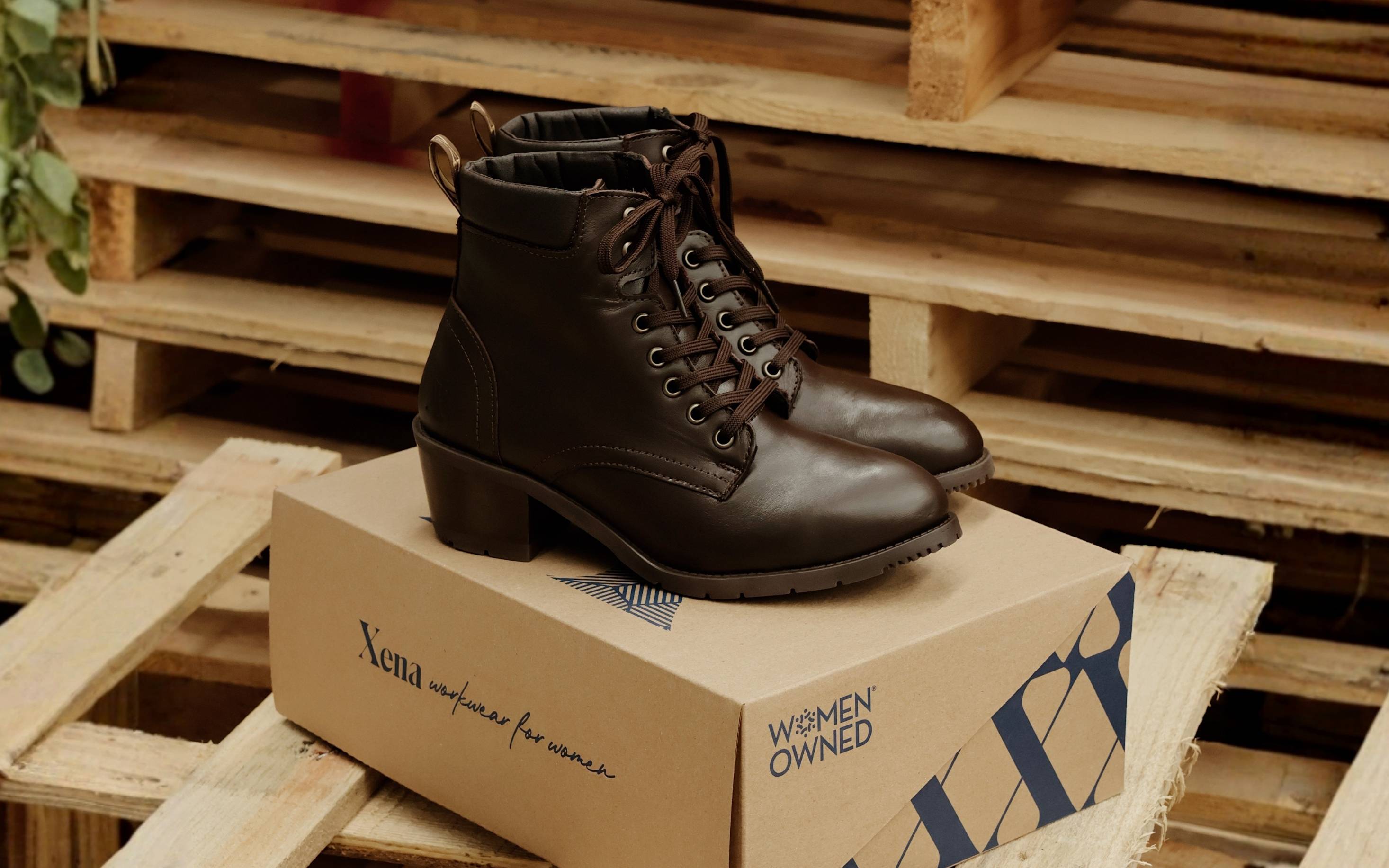 Xena Vega steel-toe safety boots in chestnut brown leather displayed on the Xena Workwear shoe box in a warehouse