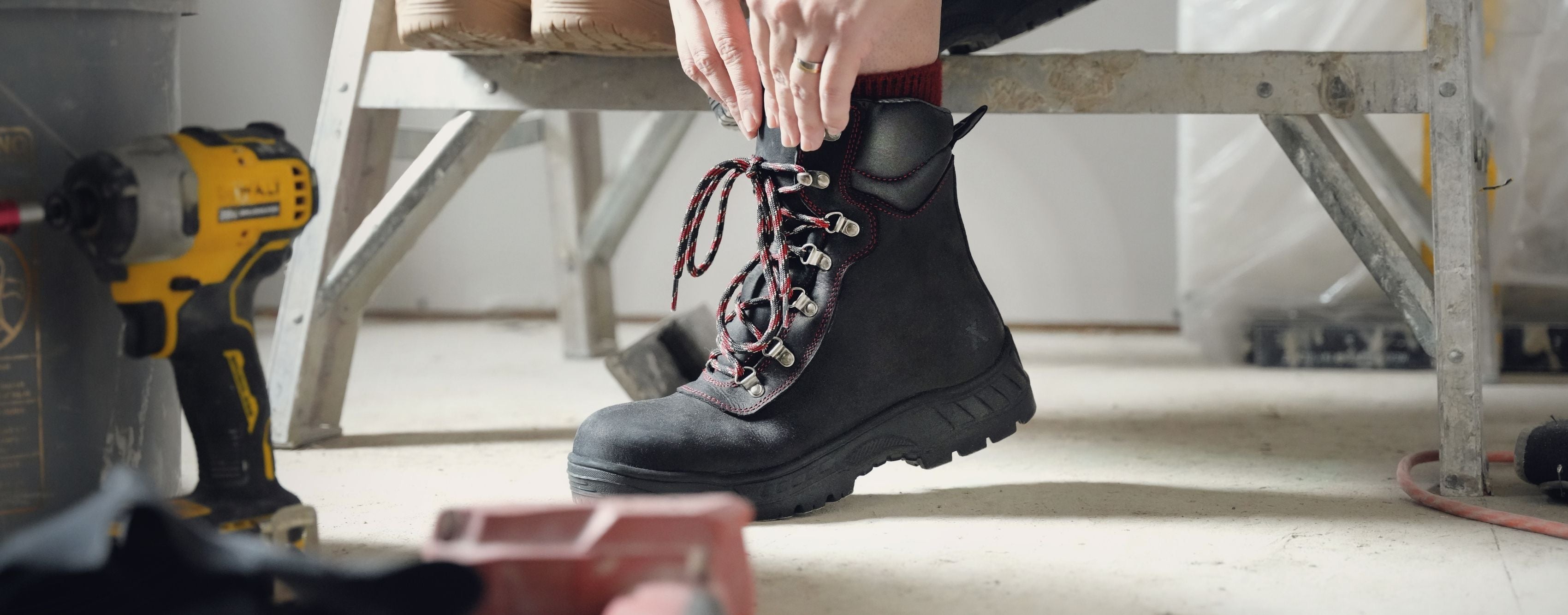 Woman on a construction jobsite wearing Xena Horizon Black safety boots