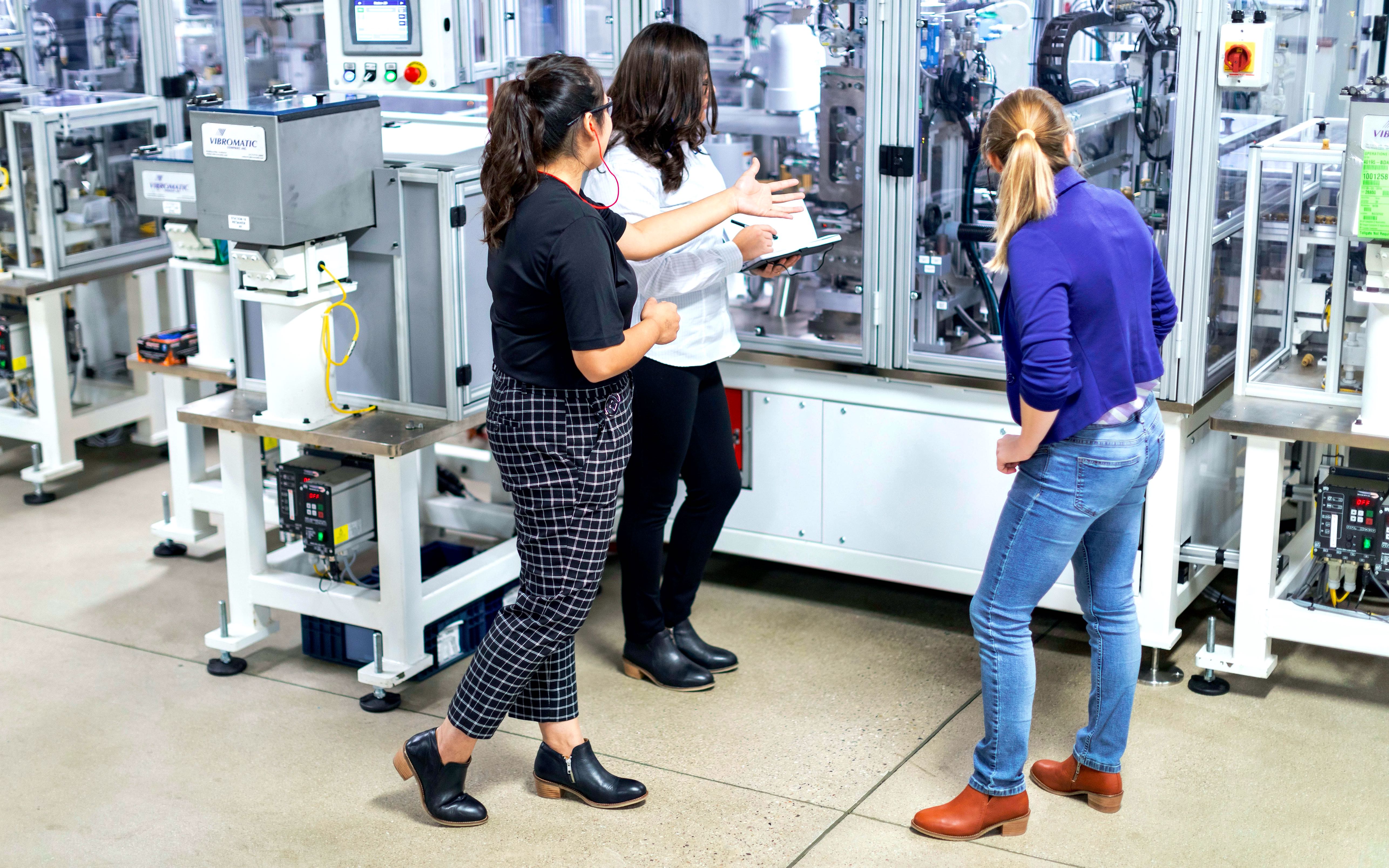 Three people at work wearing Gravity Women’s Steel Toe Boots in Black and Cognac Brown