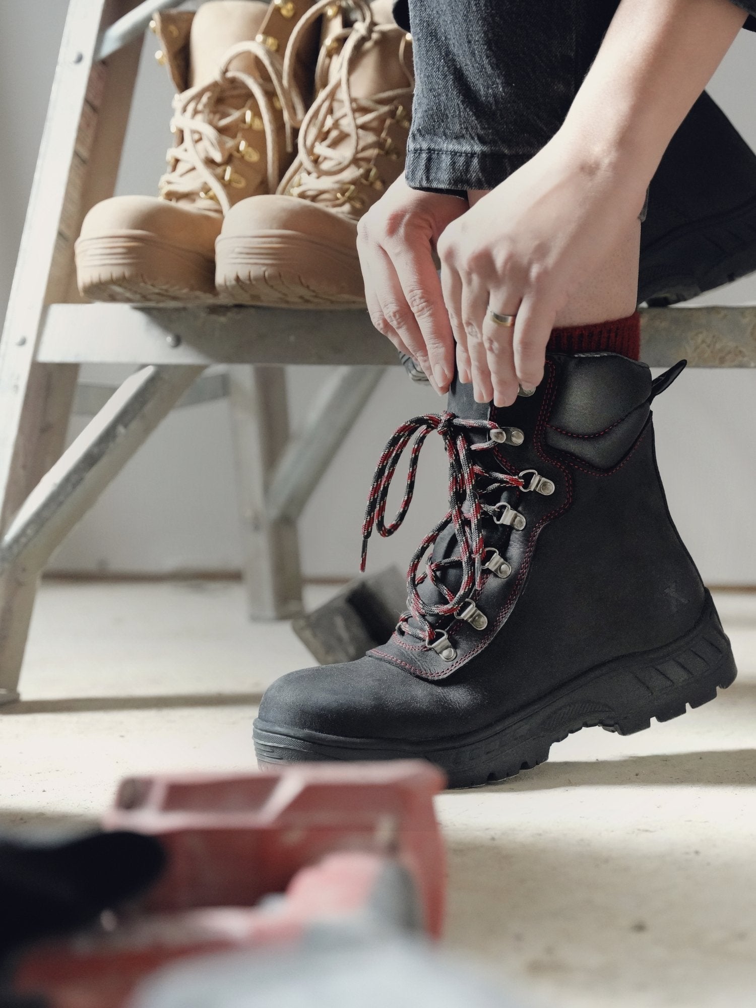 Woman on a construction jobsite wearing Xena Horizon Black safety boots